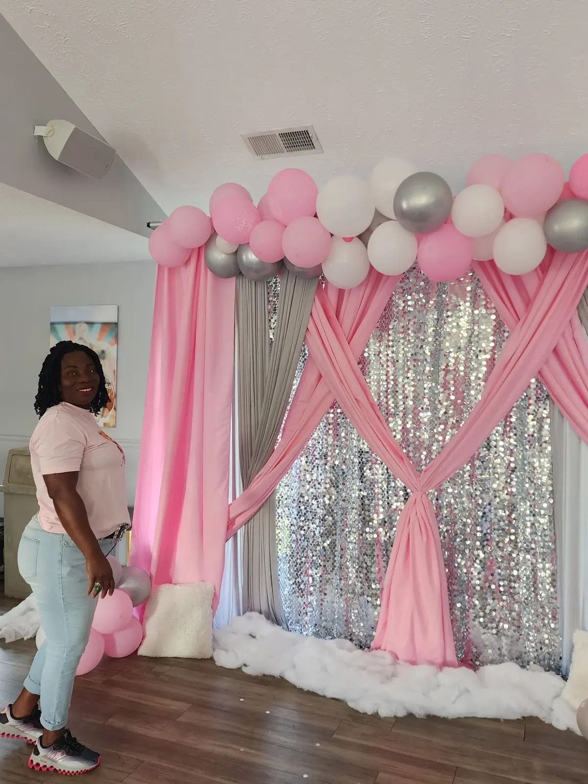 Pink balloons and draping around a silver shimmer backdrop